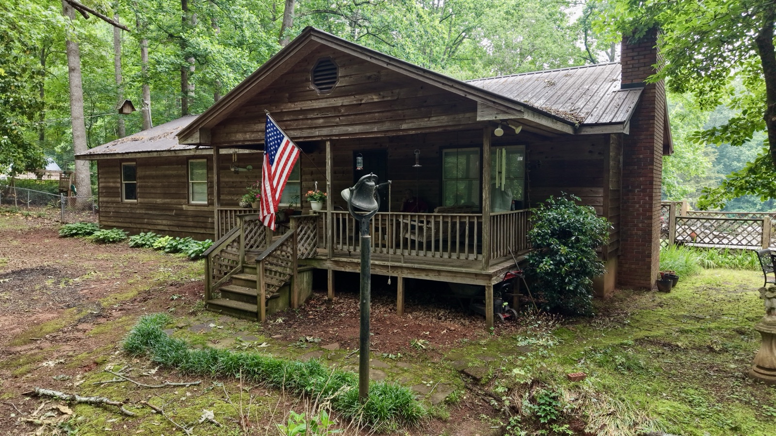 Log cabin with American flag on porch